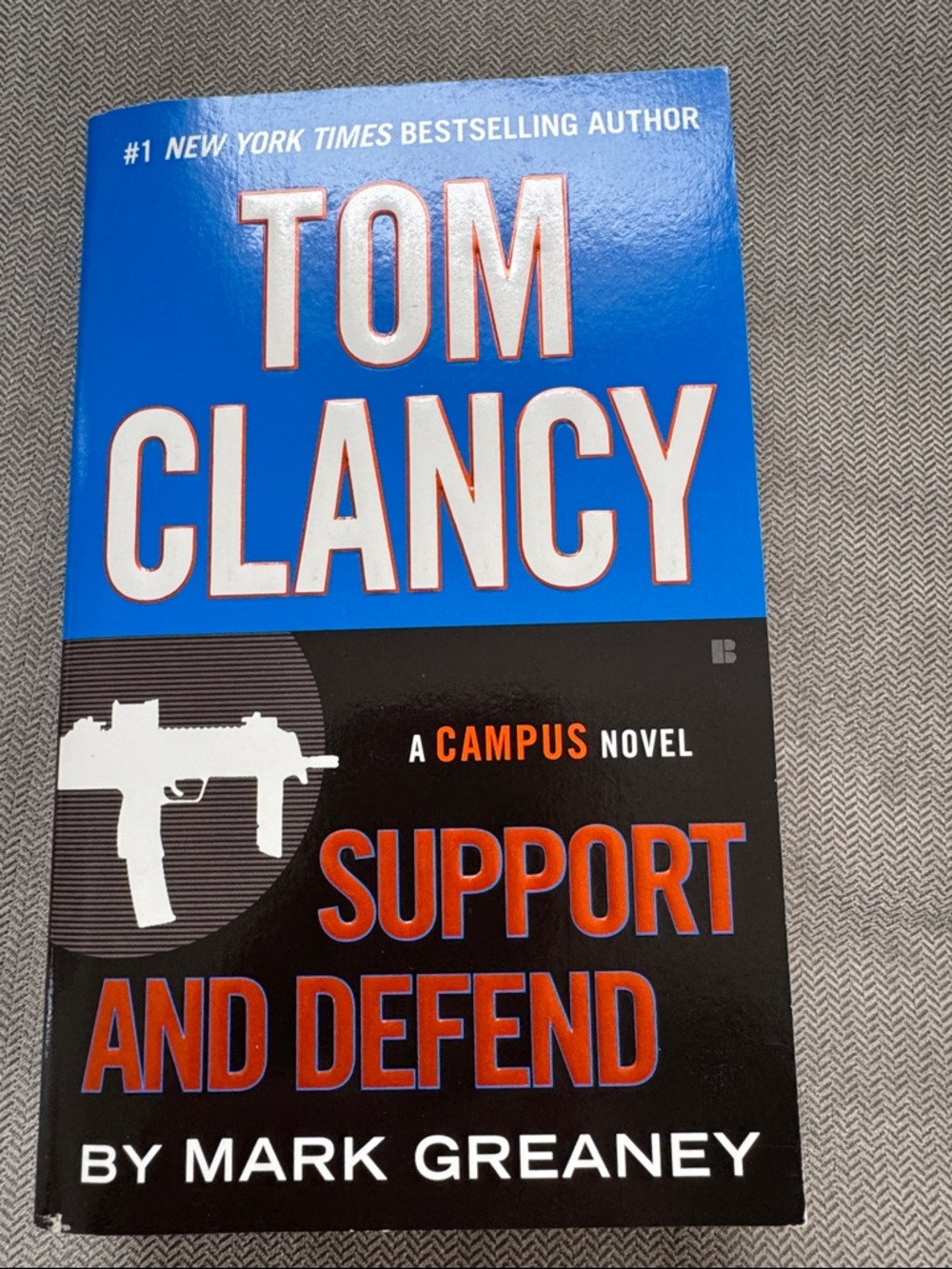 Support and Defend by Mark Greaney - Blue/Black Paperback